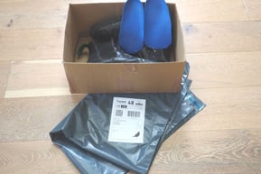 a box of shoes and a pair of custom insoles with returns envelope