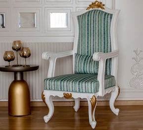 A carving chair and a table with a vase