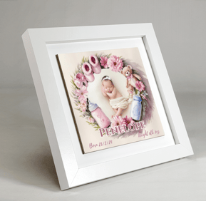 a baby's picture tile in a frame with a baby's picture in it