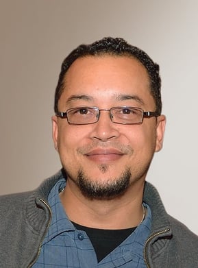 a man with glasses and a jacket on