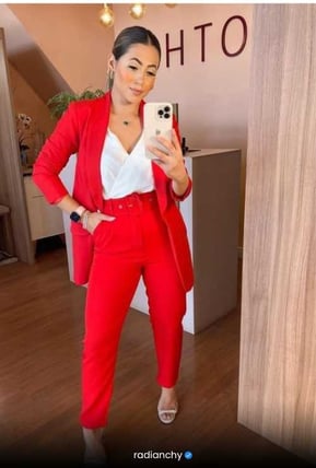 a woman in a red suit and white shirt
