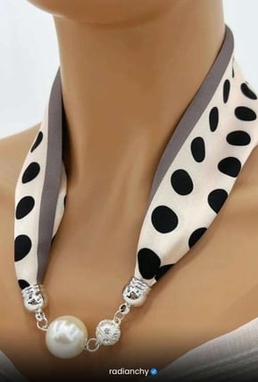 a woman wearing a polka dot dot scarf around a neck