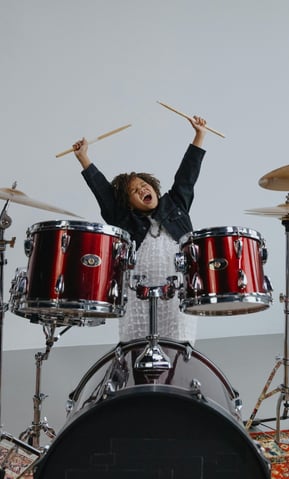 Child excited to play drums