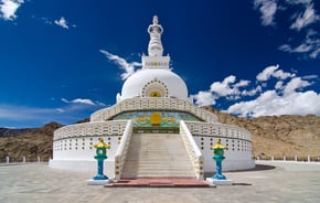a large white stuikd with a statue of a buddha
