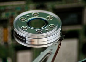 a hard drive disk with a green disk