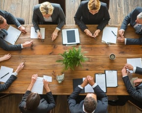 a group of business people in a meeting room