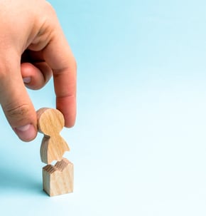Personal Injury (broken wooden figure of a person being put back together)