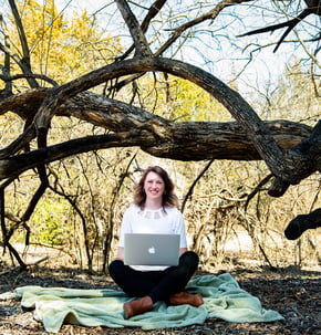 girl in nature with laptop