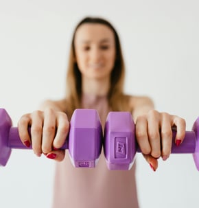 female adult lifting weights for exercise