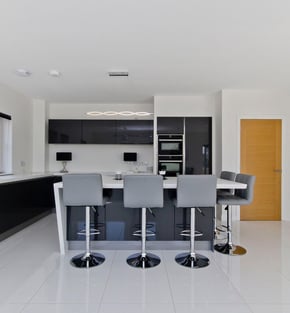 Custom kitchen in East Kilbride showcasing modern cabinets, a large island and bar seating