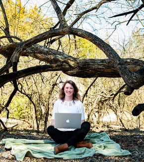 girl in woods with laptop
