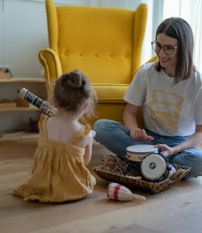 a person and a child sitting on the floor