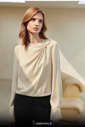a woman in a white blouse and black pants