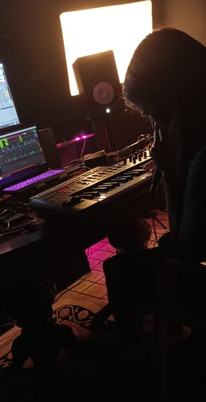 A memeber of Kalokoro Teke singing and composing in their home music studyg