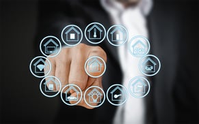 a man in a suit pointing at a circle of assistive tech and domotics icons 