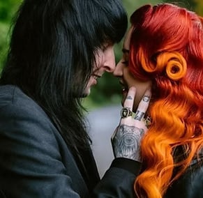 alt couple, one with black hair and the other with red to orange ombre hair