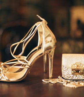 a pair of shoes and a purse on a table