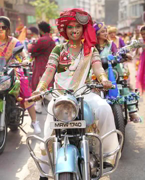 woman in maharastrian traditional outfit riding a motorbike in girgaon gudipadwa shobhayatra 2025
