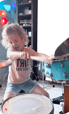 little girl playing blue drums