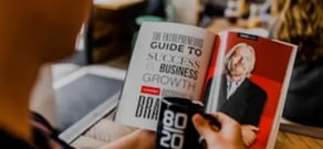 A man reading a guide to success Business