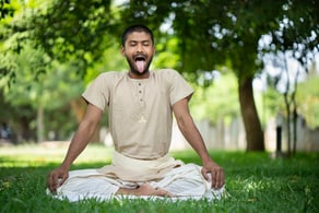 a man with a tongue sticking out of his tongue doing yoga to boost immunity