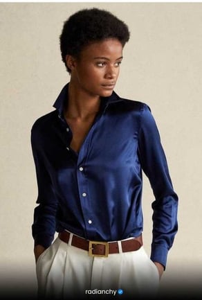 a woman in a blue shirt and white pants