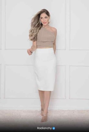 a woman in a white skirt and crop top