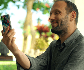 Man Videochatting On Phone and Showing Off His Garden