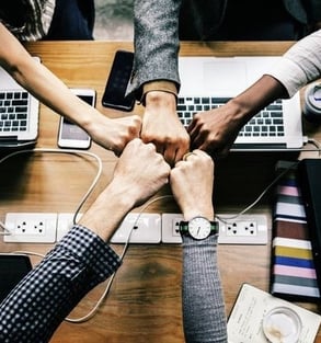 a group of people holding hands in a circle