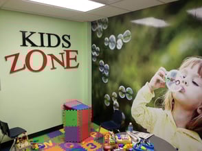 Custom graphics of a little girl blowing bubbles for a children's play area at a car dealership