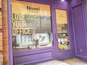 Storefront graphics with perforated vinyl for Novel Coworking.