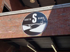 Aluminum Composite Sign with full color digital graphics installed on the brick face of an apartment complex