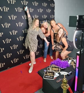 A group of volunteers at the Ormeau Shearers Rugby Club posing in the VIP red carpet digital photo booth at their event in th