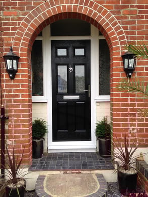 a black front door 2 panel 2 square glass with side panels