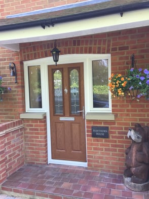 oak wood colour composite door with decorative glass and half glazed side panels