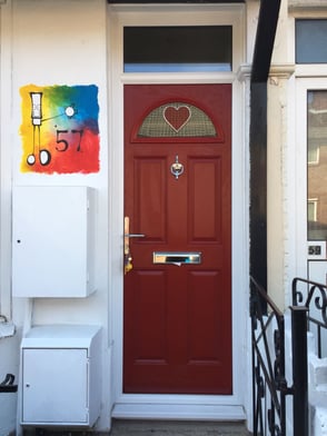 narrow red composite door with bespoke heart glass