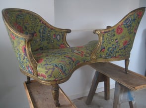 Antique gilded loveseat with new upholstery and a modern floral green fabric