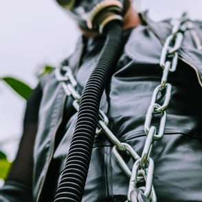 FTSH Studios model (s) Oscar Thickk UK Fetish Model wearing farmerrain bodysuit, gloves, gas mask, chain