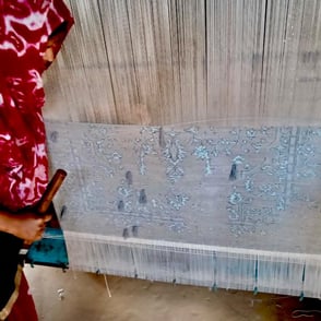A tour of an art-workshop where a craftswoman is weaving a carpet on an age-old loom