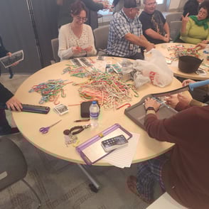 group of people sitting at round table filled with candy canes