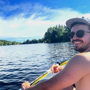 William, founder of Notionbase, kayaking on a lake