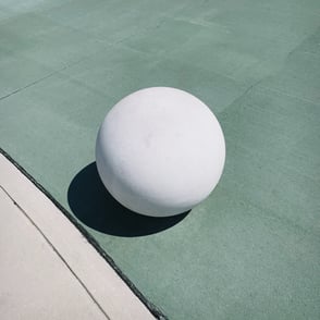 White ball on green concrete