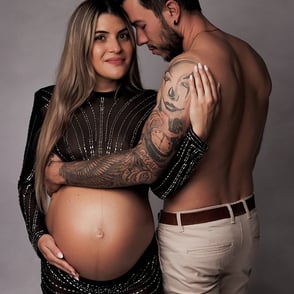 séance photo grossesse en couple, bras dessus, dessous entourant le ventre de maman