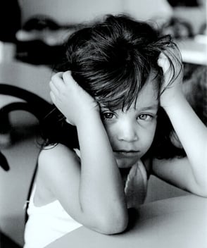 Tired little girl black and white photo hands on head
