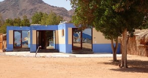 3 Studios blue building with a mountain in the background