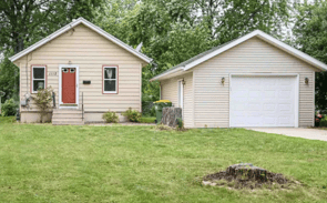 a house with a garage door and a garage door
