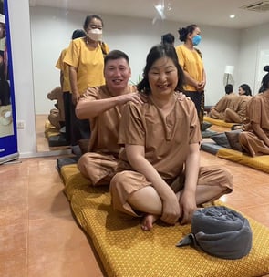 a group of people partaking in thai massage class