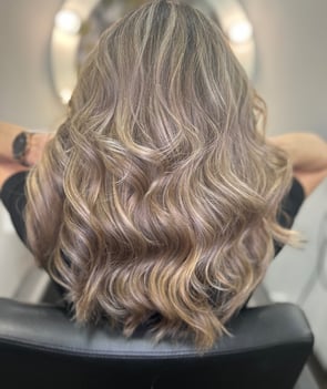 a woman with blonde hair balayage