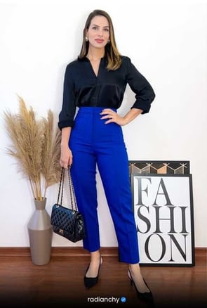 a woman in a black shirt and blue pants