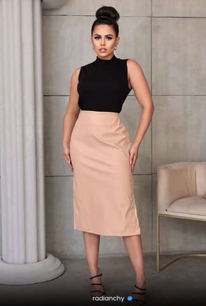 a woman in a black top and skirt with a black top